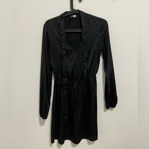 Black flowy dress with a deep neck and tie from H & M in size UK 8
